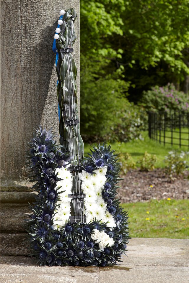 <h2>Bespoke Electric Guitar Tribute | Funeral Flowers</h2>
<ul>
<li>Approximate Size 97 x 40cm</li>
<li>Hand created electric guitar in fresh flowers</li>
<li>To give you the best we may occasionally need to make substitutes</li>
<li>Funeral Flowers will be delivered at least 2 hours before the funeral</li>
<li>For delivery area coverage see below</li>
</ul>
<br>
<h2>Liverpool Flower Delivery</h2>
<p>We have a wide selection of Bespoke Funeral Tributes offered for Liverpool Flower Delivery. Bespoke Funeral Tributes can be provided for you in Liverpool, Merseyside and we can organize Funeral flower deliveries for you nationwide. Funeral Flowers can be delivered to the Funeral directors or a house address. They can not be delivered to the crematorium or the church.</p>
<br>
<h2>Flower Delivery Coverage</h2>
<p>Our shop delivers funeral flowers to the following Liverpool postcodes L1 L2 L3 L4 L5 L6 L7 L8 L11 L12 L13 L14 L15 L16 L17 L18 L19 L24 L25 L26 L27 L36 L70 If your order is for an area outside of these we can organise delivery for you through our network of florists. We will ask them to make as close as possible to the image but because of the difference in stock and sundry items it may not be exact.</p>
<br>
<h2>Liverpool Funeral Flowers | Bespoke Tributes</h2>
<p>This electric guitar shaped funeral design has been loving handcrafted by our expert florists. It features a mass of spray chrysanthemums and is an ideal tribute for a musician or guitar player.</p>
<br>
<p>Bespoke Funeral Tributes are a way to create a tribute that is truly unique and specially designed for a loved one.</p>
<br>
<p>These are sometimes selected by family members as the main tribute or more often a group of friends or workplace colleagues as a symbol of things they associate with the deceased.</p>
<br>
<p>The flowers are arranged in floral foam, which means the flowers have a water source so they look their very best for the day.</p>
<br>
<p>Contains 20 white spray chrysanthemums, 15 blue eryngium, 10 cordyline fruticosa and decorated with silver wire, black midelino sticks, white beads and pearl pins.</p>
<br>
<h2>Best Florist in Liverpool</h2>
<p>Trust Award-winning Liverpool Florist, Booker Flowers and Gifts, to deliver funeral flowers fitting for the occasion delivered in Liverpool, Merseyside and beyond. Our funeral flowers are handcrafted by our team of professional fully qualified who not only lovingly hand make our designs but hand-deliver them, ensuring all our customers are delighted with their flowers. Booker Flowers and Gifts your local Liverpool Flower shop.</p>
<br>
<p><em>Debera G - 5 Star Review on yell.com - Funeral Florist Liverpool</em></p>
<br>
<p><em>Fleur and her team made the flowers for my Dad's funeral. I knew I wanted something quite specific but was quite unsure how to execute the idea. Fleur understood immediately what I was hoping to achieve and developed the ideas into amazingly beautiful flowers that were just perfect. I honestly can't recommend her highly enough - she created something outstanding and unique for my Dad. Thanks Fleur.</em></p>
